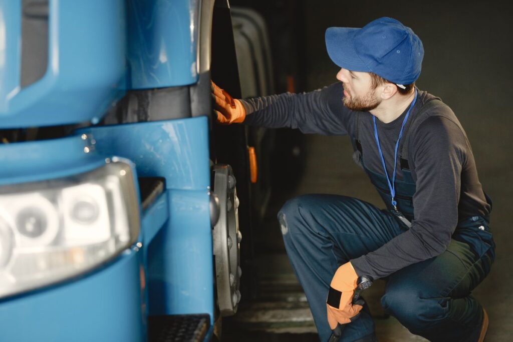 Mechanic checking a vehicle's wheel in a garage
