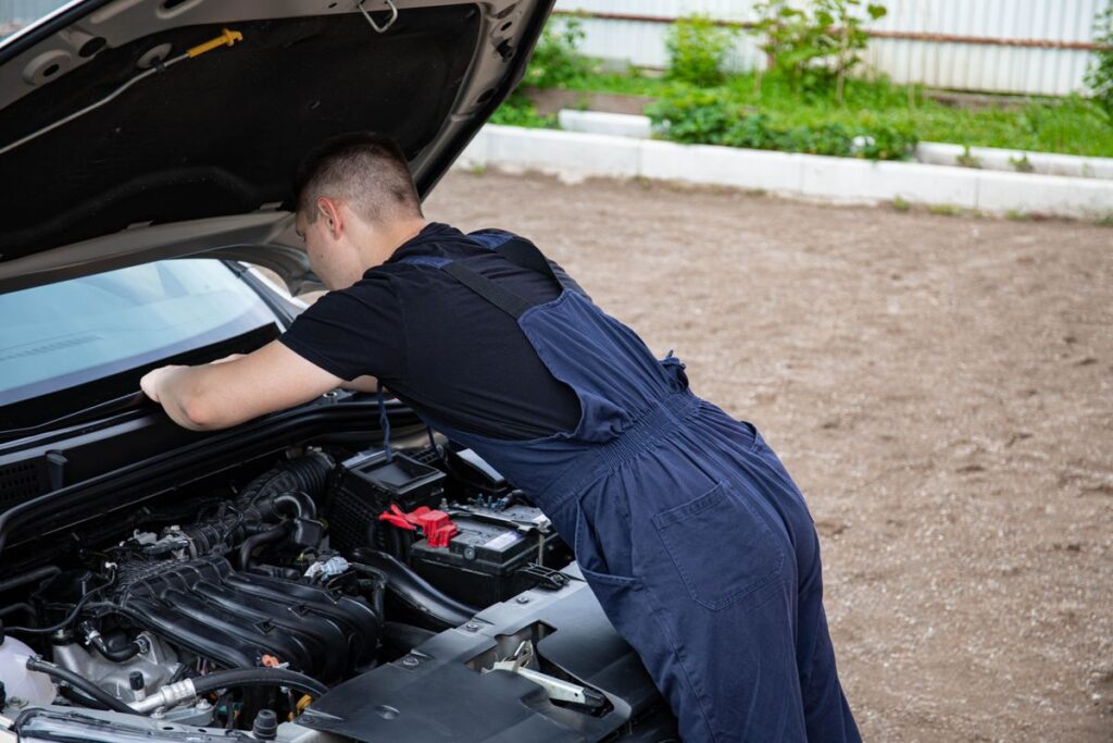 Mechanic leaning into an engine bay