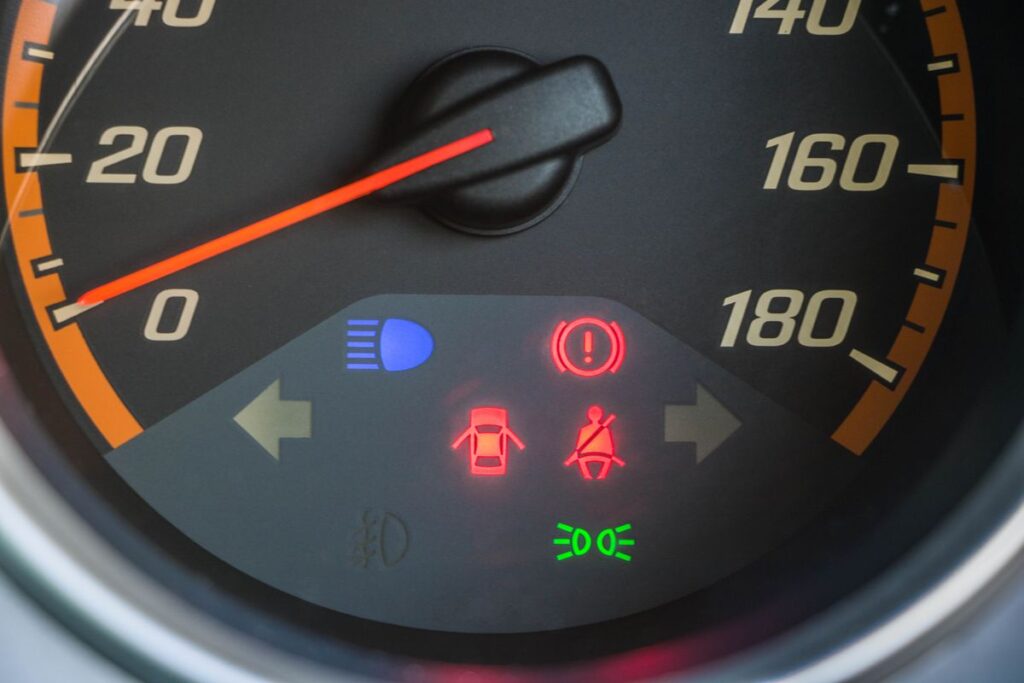Speedometer with dashboard warning lights lit up
