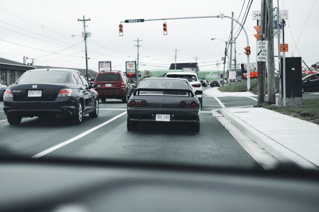 Traffic stopped at an intersection seen from the driver's seat
