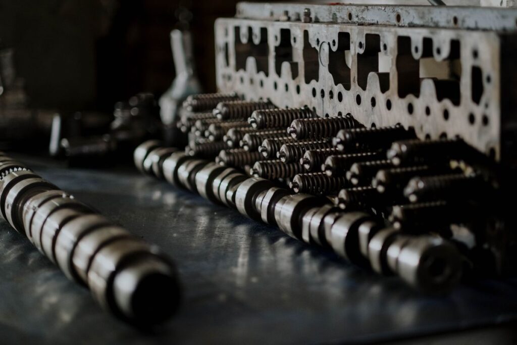Camshafts and valve springs laid out on a workbench