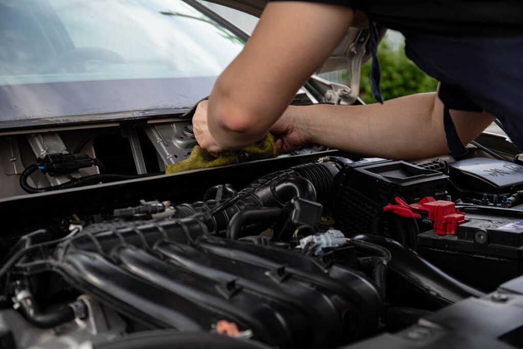 Hands working in a car engine bay