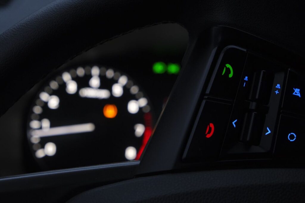 Dashboard warning lights glowing at night