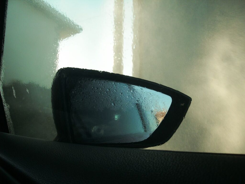 Side mirror seen through a fogged side window