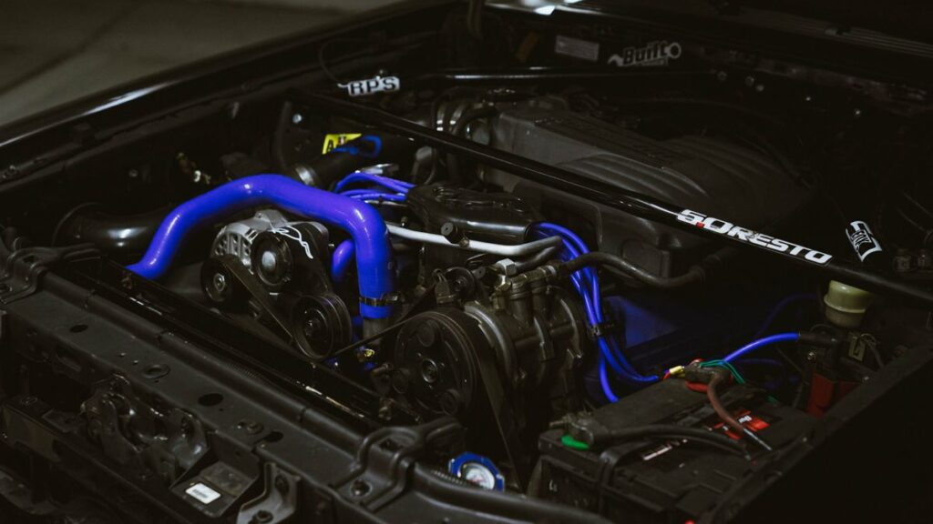 Engine bay with blue hoses and intake piping