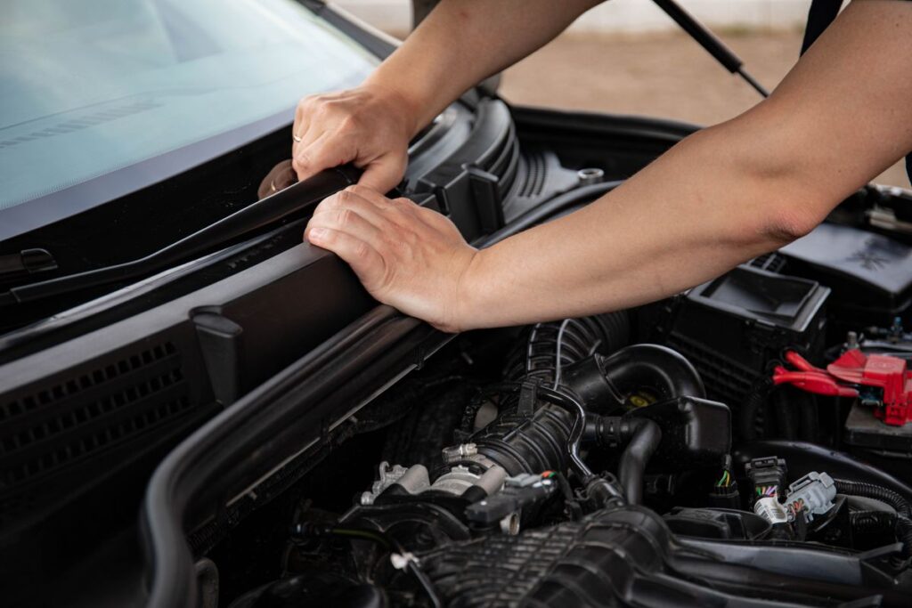 Hands working in an engine bay