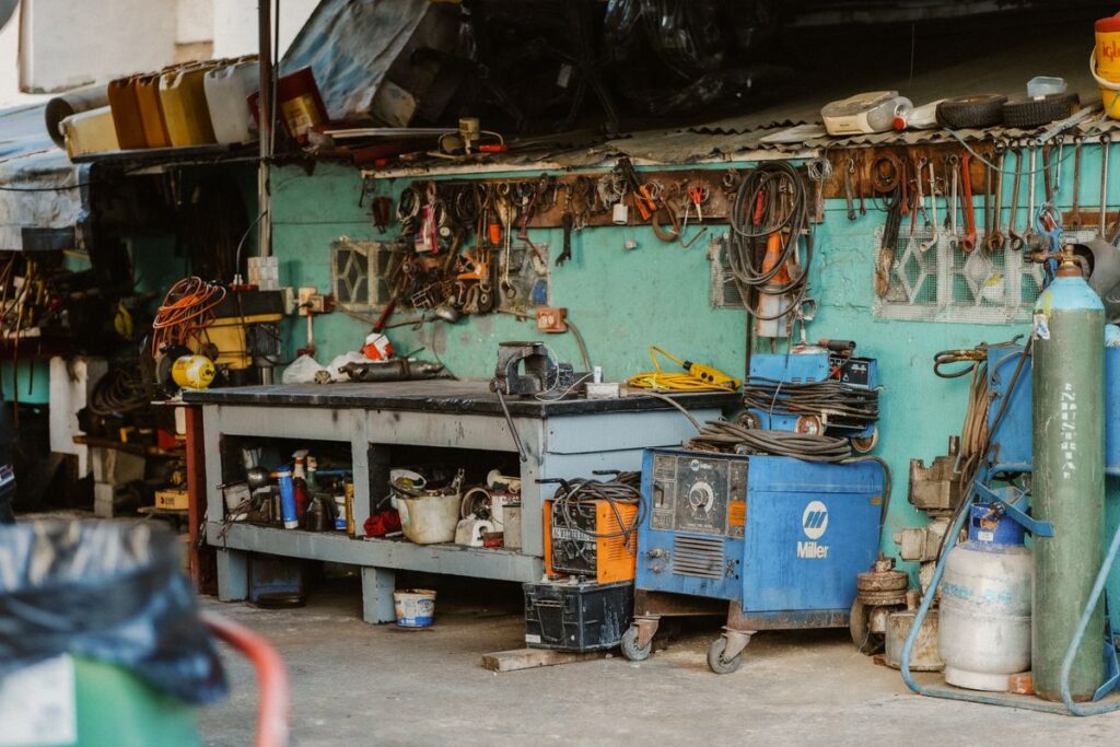 Cluttered auto workshop with tools and equipment