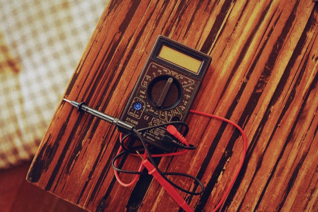 Digital multimeter with test leads on a table