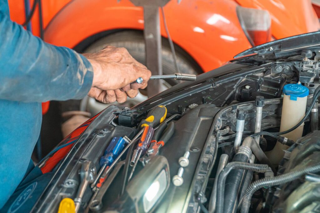 Hands working in an engine bay