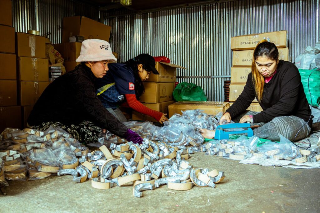 Workers packing brake parts in a warehouse