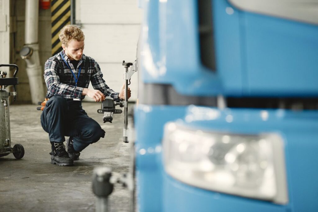 Mechanic setting up wheel service equipment in a shop
