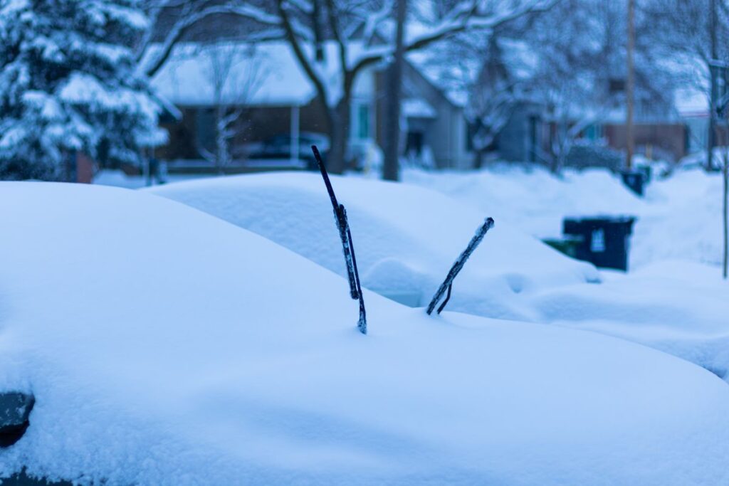 Car covered in snow on a quiet street on a winter morning
