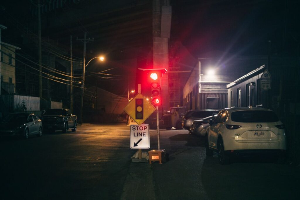 Cars stopped at a red light at night
