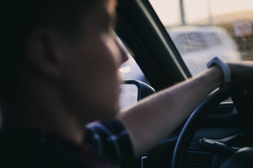 Driver's hand on the steering wheel during a test drive
